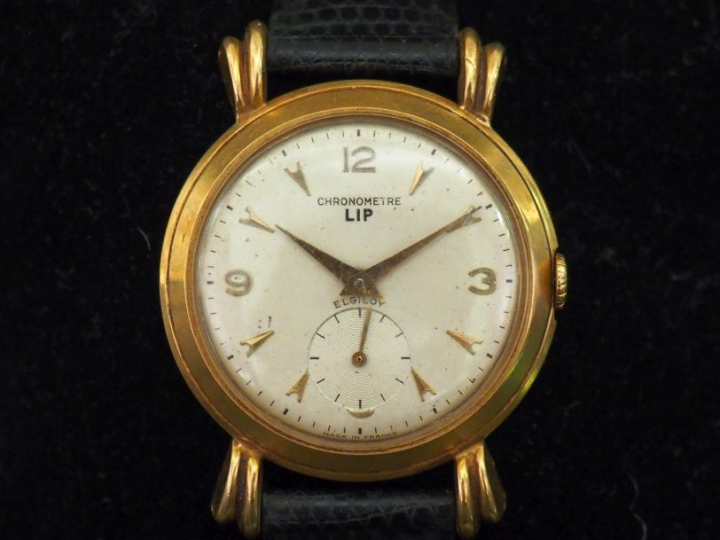 LIP, Elgiloy Montre bracelet, boitier en or jaune 750. Cadran rond à c