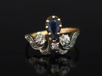 Vente aux enchères Bague en or jaune 750, à décor d'une fleur de lys sertie d'un saphir e