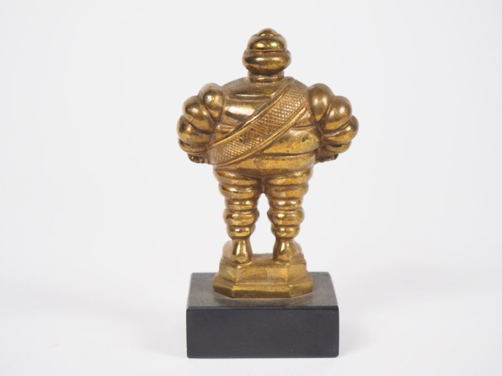 MICHELIN.  Bibendum, sujet en bronze doré sur un socle en marbre noir.
