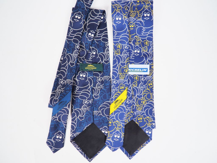 LONGCHAMP.  Deux cravates en soie à décor de Bibendum.