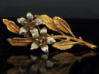 Vente aux enchères Broche deux tons d'or 750, en forme de branchage fleuri.  H. 6,5 cm Po