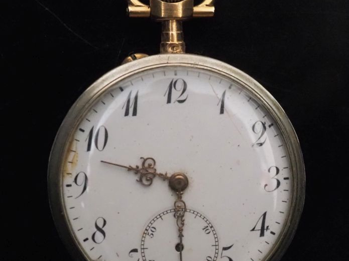 Montre de gousset en or jaune 750 et métal.  Cadran à chiffres arabes 