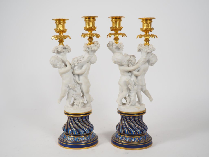 SEVRES.  Paire de bougeoirs doubles en porcelaine polychrome, bronze d