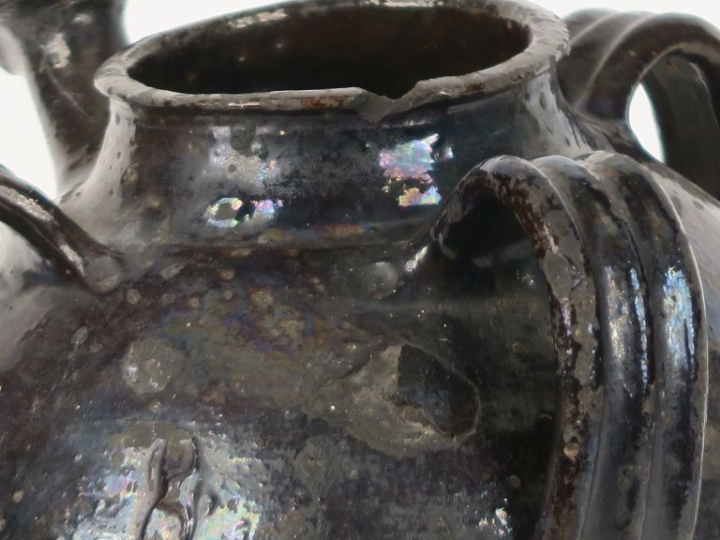 Jarre à huile en terre vernissée noire, à trois anses ajourées.  H. 30