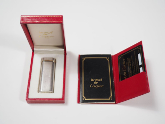 Vente aux enchères CARTIER, Must Briquet en métal argenté et doré.  Signé. Numéroté 37066