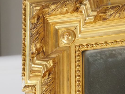 Grande glace de cheminée de style Louis XVI en bois et stuc doré. Dim.