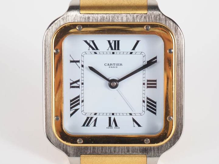 CARTIER, SANTOS Pendulette de table / réveil en acier et métal doré.  