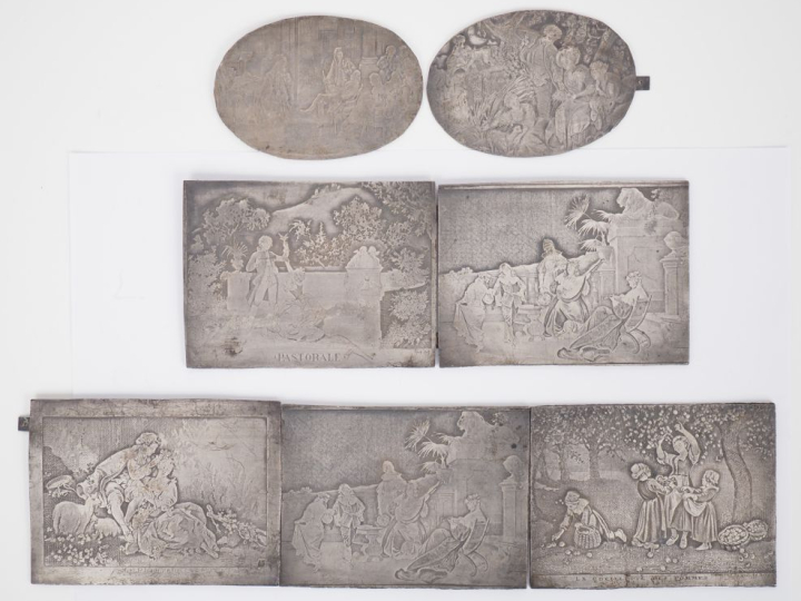 7 différentes plaques en métal ciselé à décor de scènes galantes. Dim.