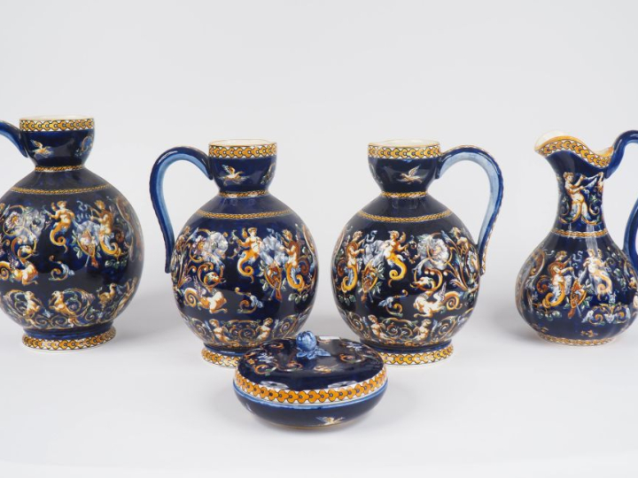 GIEN.  4 différentes verseuses en faience, décor de style Renaissance 